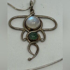 Silver tone moonstone and green stone artisan pendant and chain marked Italy.